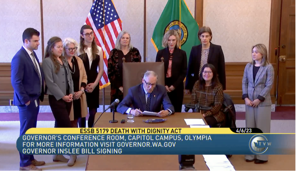 Charmaine Manansala chief advocacy officer for Compassion and Choices Action Network  proudly watches Washington Governor Jay Inslee sign SB 5179 into law