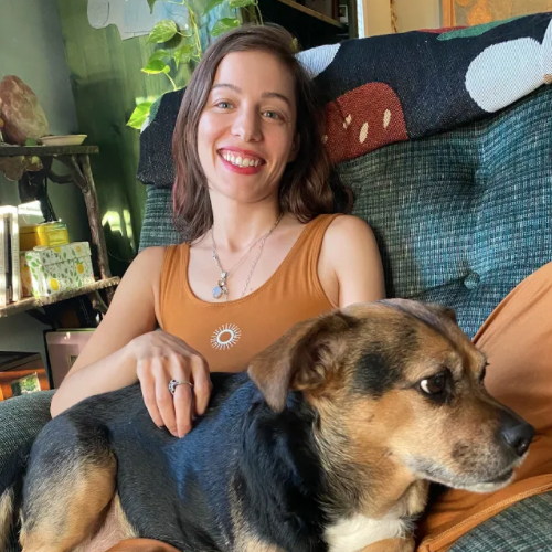 Sophie Meyn seated petting her dog
