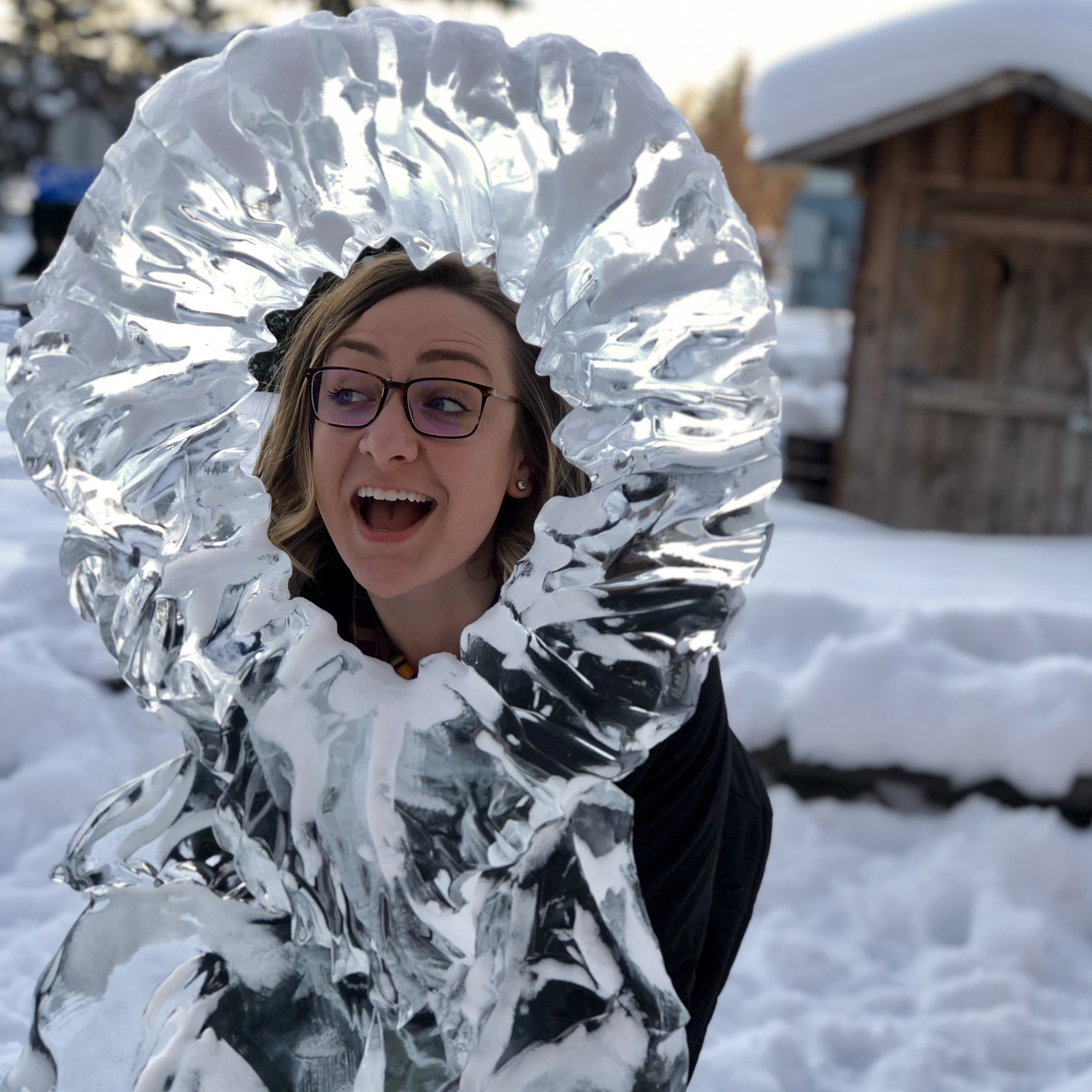 Rachel Bernhardt posing behind an ice sculpture