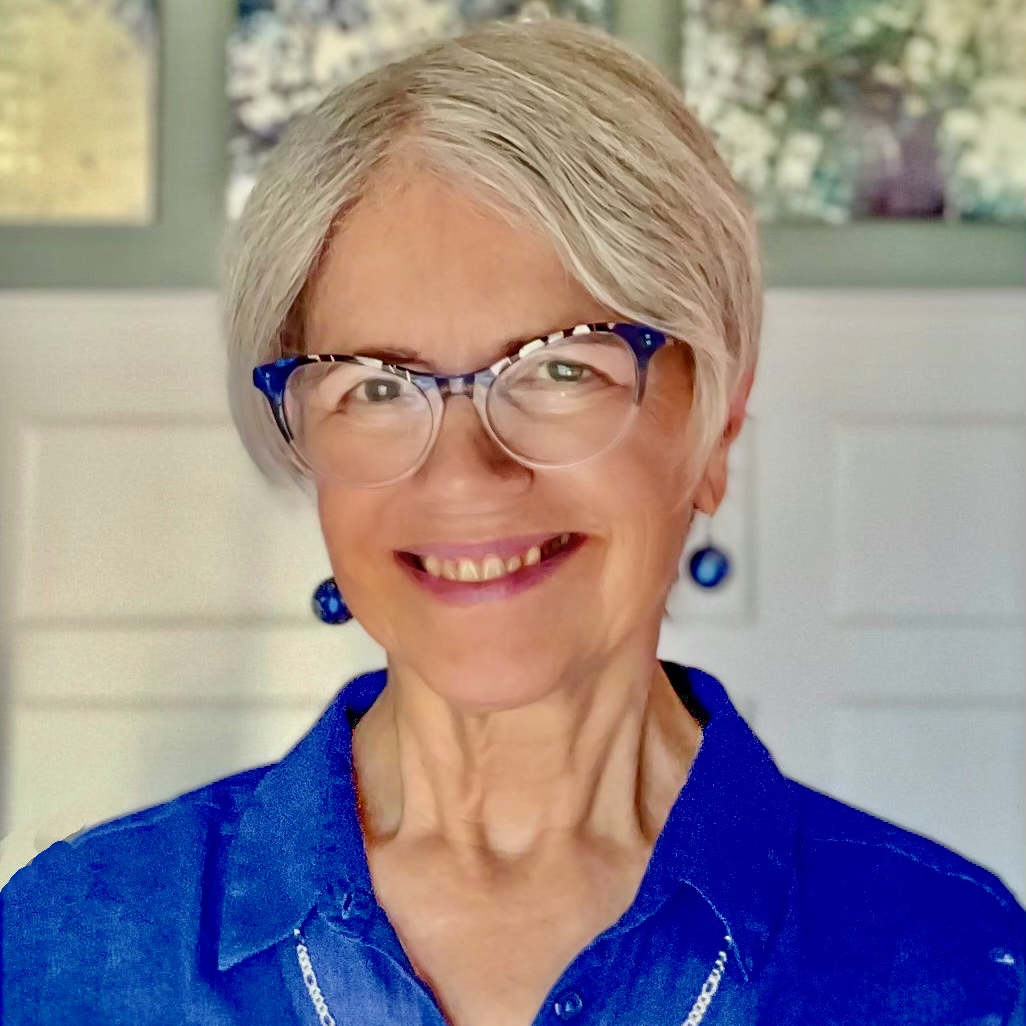 Susan Spencer smiling, wearing a blue shirt.